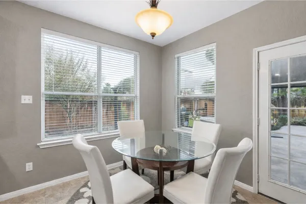 a view of a dining room with furniture and windows