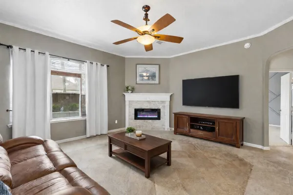 a living room with furniture fireplace and flat screen tv