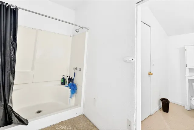 a bathroom with a bathtub and a shower