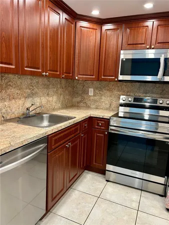 a kitchen with granite countertop a stove and a sink