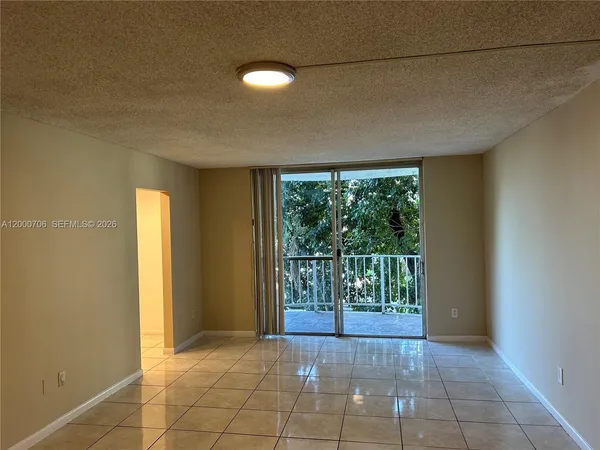 a view of empty room with floor to ceiling window