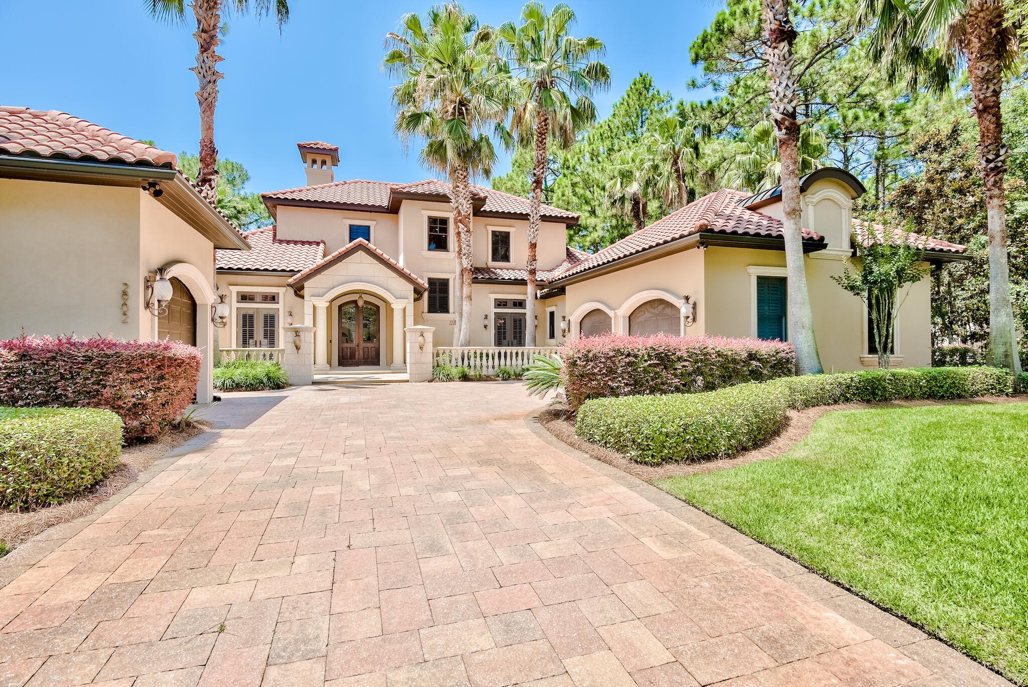 2902 Pine Valley Road Miramar Beach, FL 32550 - Photo 1 of 89 a front view of a house with a garden and plants