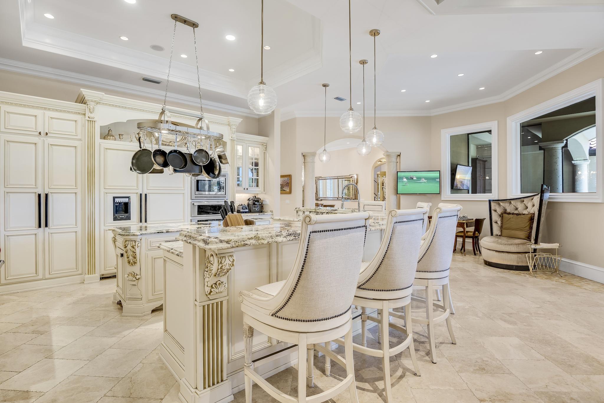 2902 Pine Valley Road Miramar Beach, FL 32550 - Photo 18 of 89 a dining room kitchen with stainless steel appliances kitchen island granite countertop a table and chairs