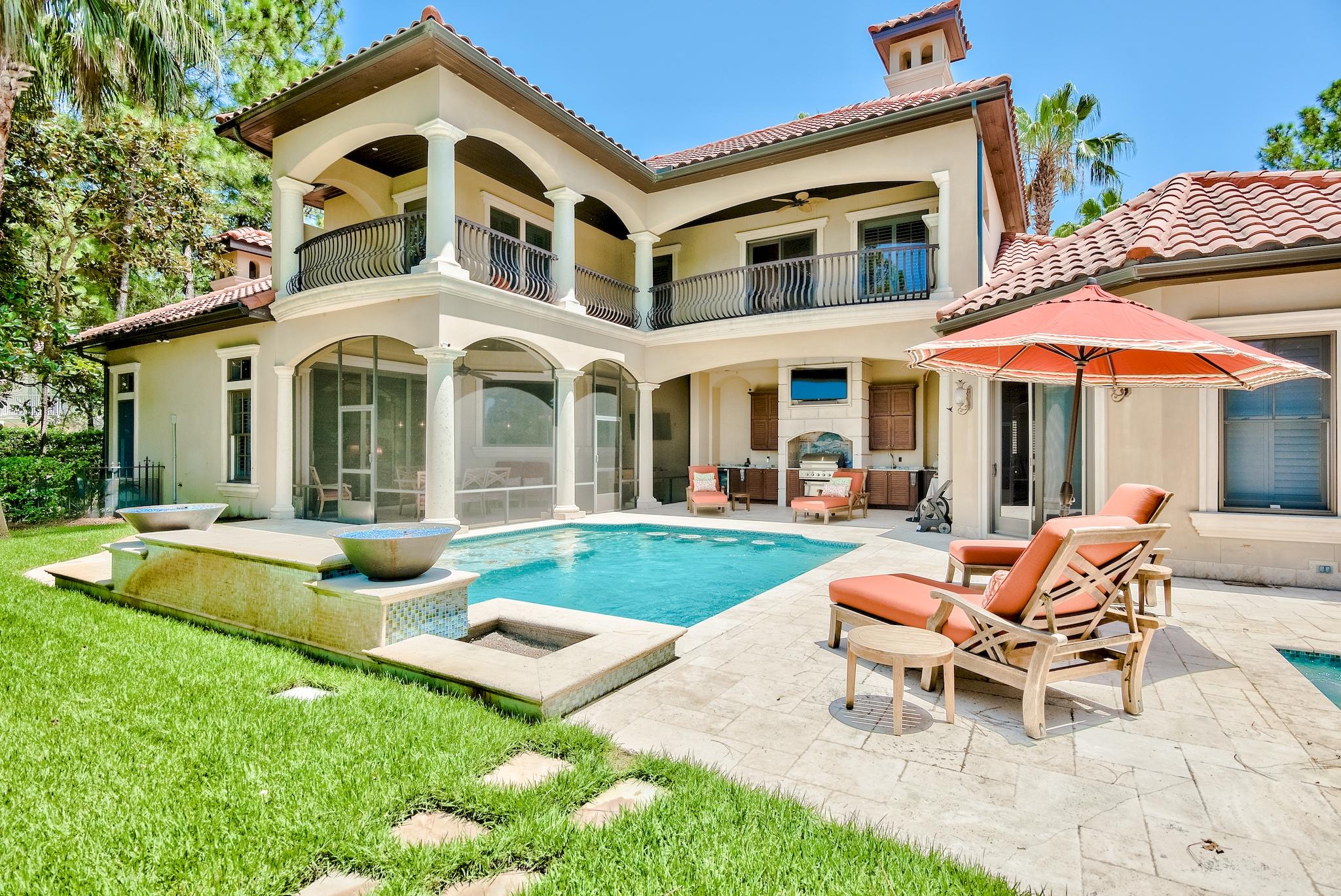 2902 Pine Valley Road Miramar Beach, FL 32550 - Photo 64 of 89 a patio with a table and chairs under an umbrella