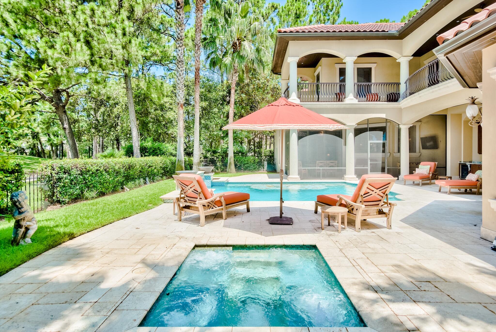 2902 Pine Valley Road Miramar Beach, FL 32550 - Photo 8 of 89 a view of a patio with table and chairs under an umbrella