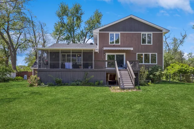 a front view of a house with a yard and green space