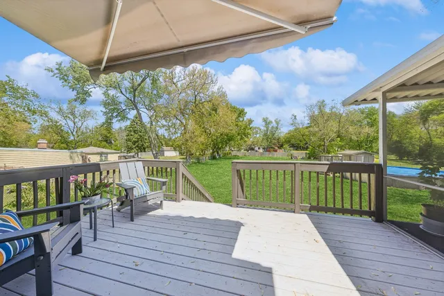 a view of balcony with wooden floor and seating space