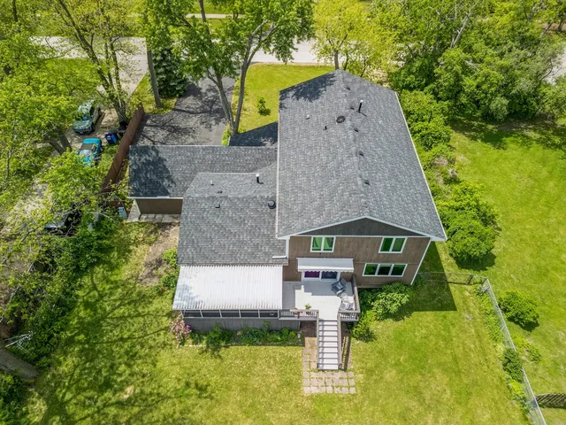 an aerial view of a house with swimming pool and garden