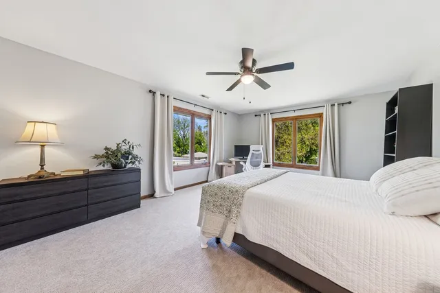 a bed room with a bed mirror and a window