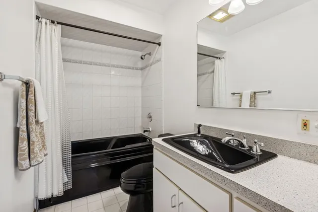 a kitchen with a refrigerator and a stove top oven