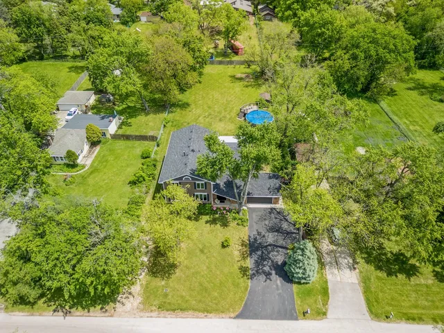 a view of a hallway with dining room and wooden floor