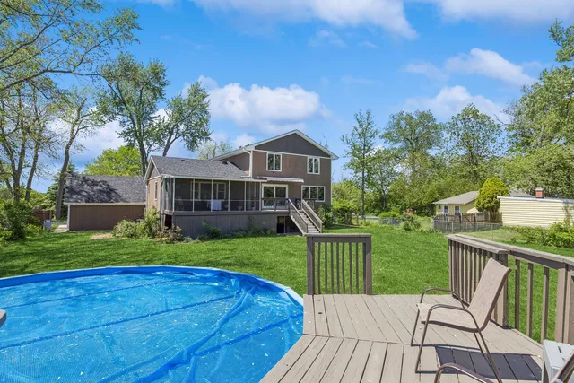 a view of a house with backyard and porch