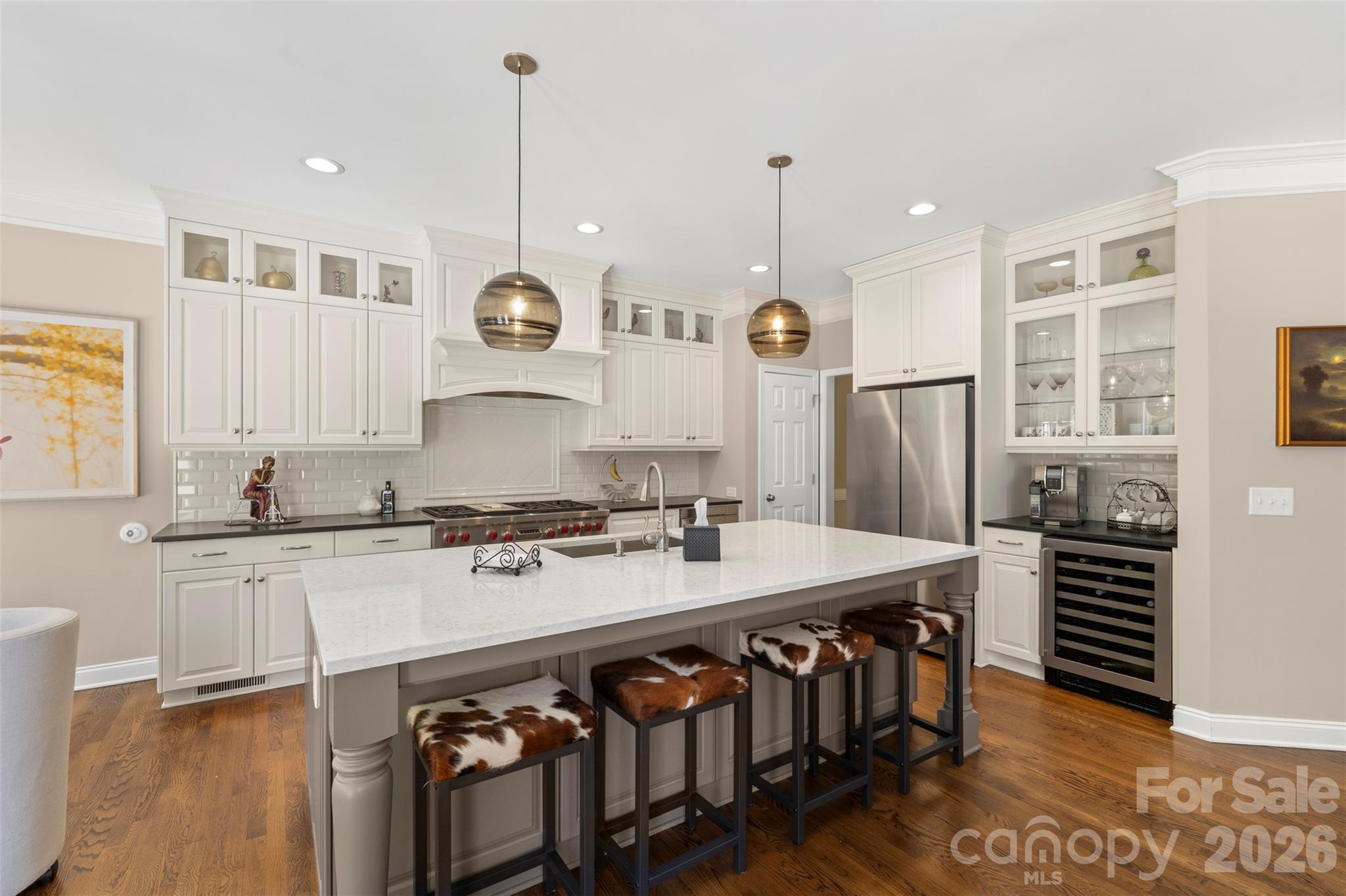 2003 Bauer Place Waxhaw, NC 28173 - Photo 17 of 47 a kitchen with stainless steel appliances granite countertop a stove a sink dishwasher a refrigerator and white cabinets with wooden floor
