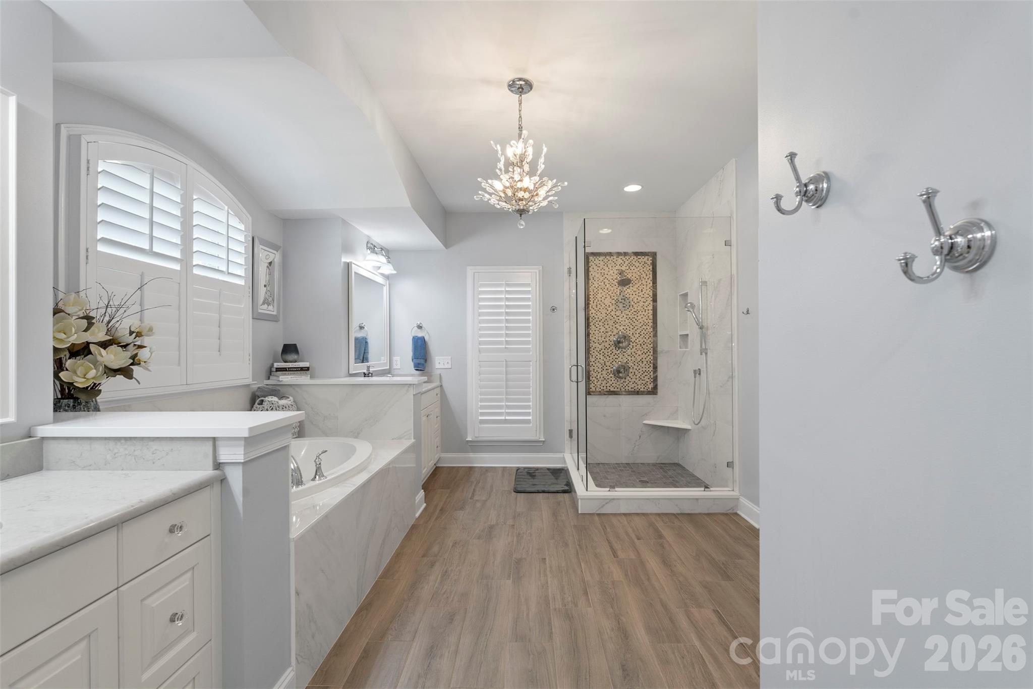 2003 Bauer Place Waxhaw, NC 28173 - Photo 26 of 47 a bathroom with a double vanity sink a large mirror a bathtub and shower