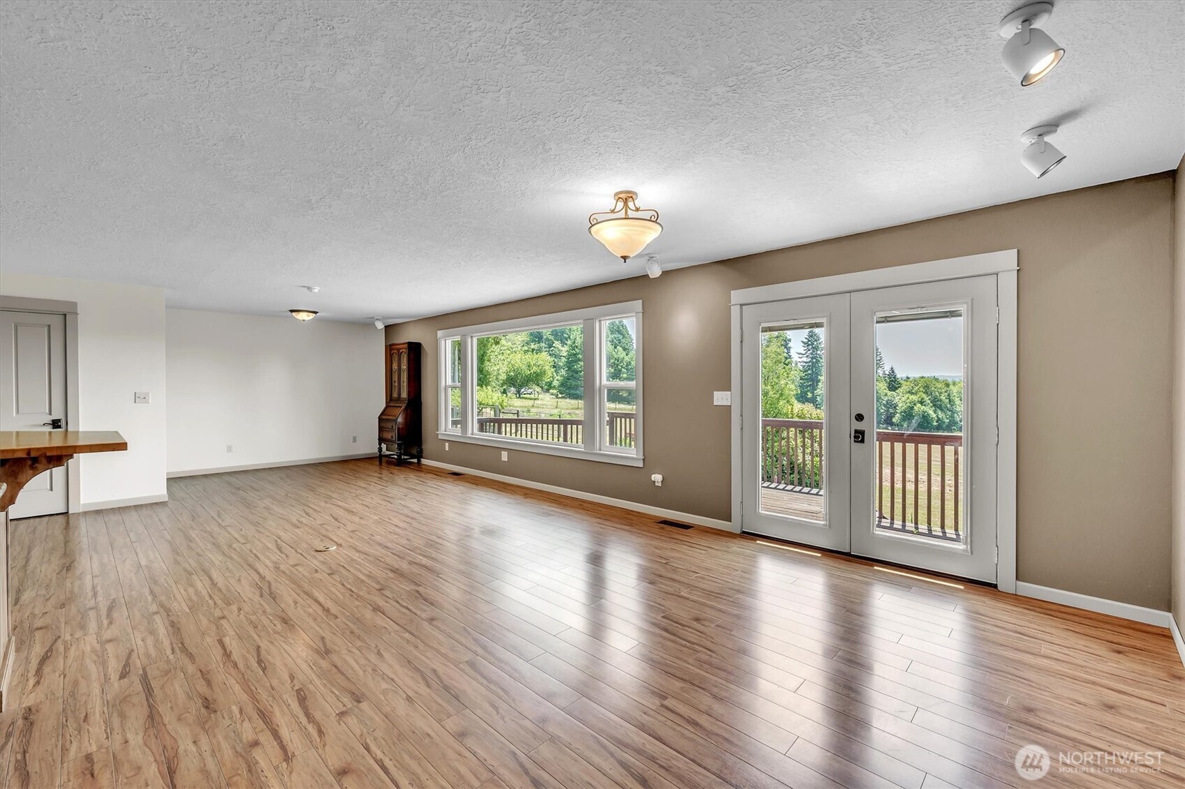 231 Robertson Road Longview, WA 98632 - Photo 12 of 37 a view of an empty room with wooden floor and a window