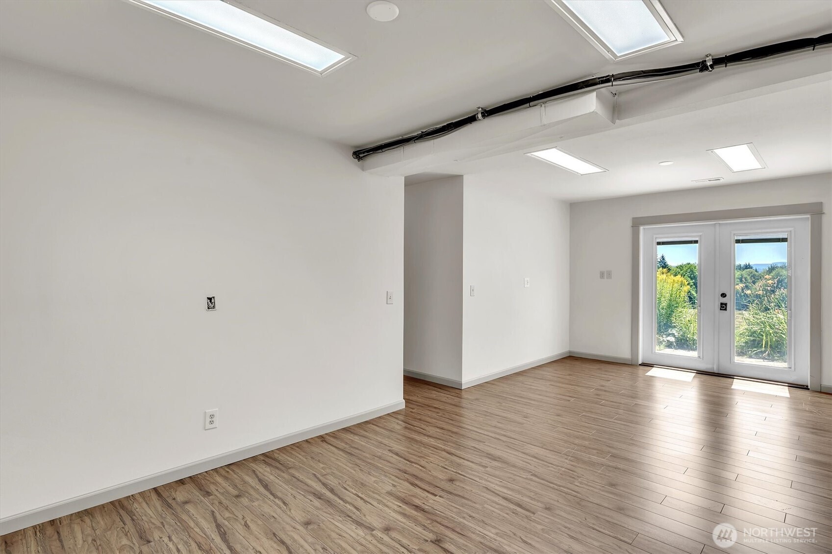 231 Robertson Road Longview, WA 98632 - Photo 18 of 37 a view of an empty room with window and wooden floor