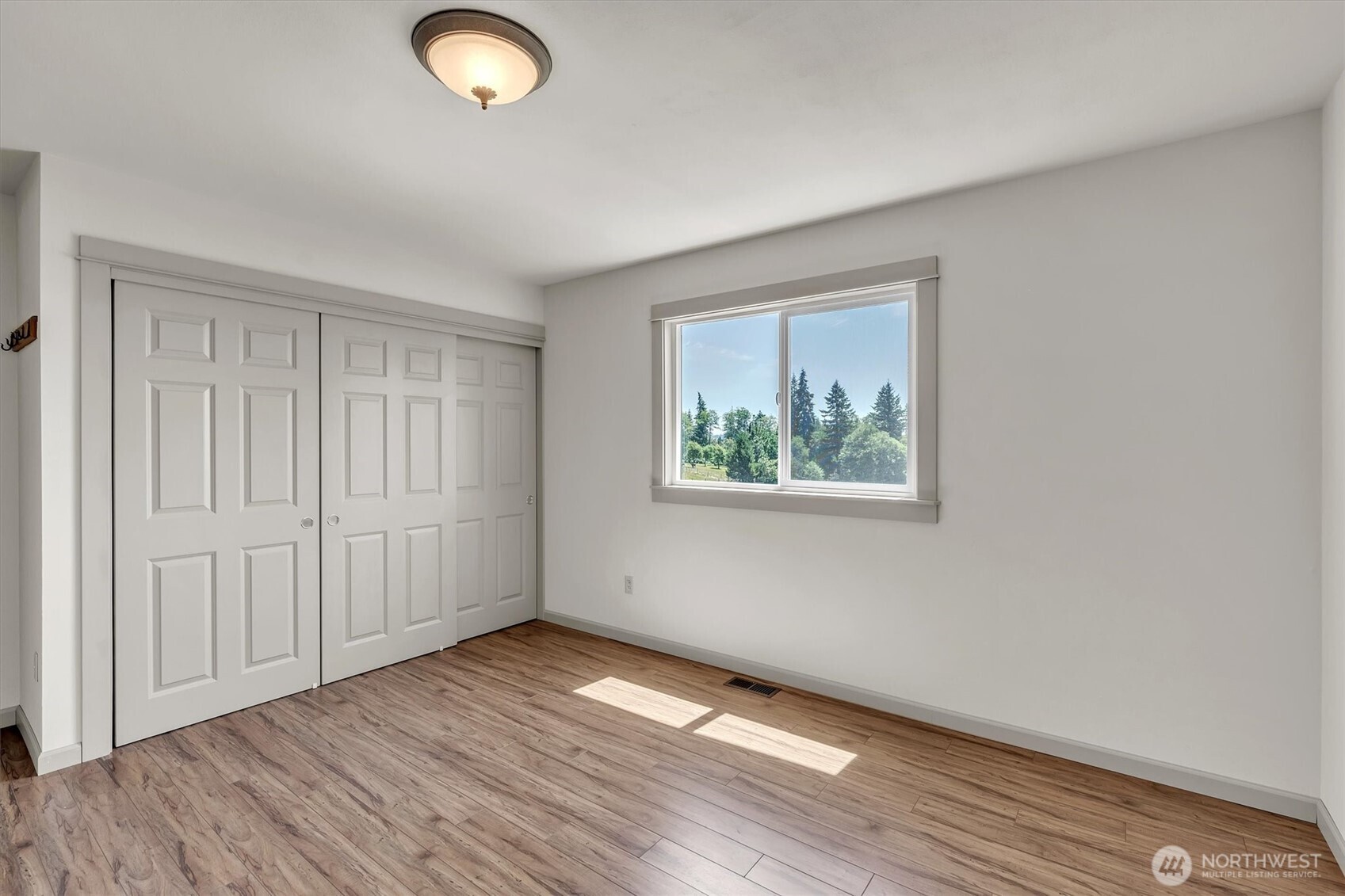 231 Robertson Road Longview, WA 98632 - Photo 20 of 37 an empty room with wooden floor and windows