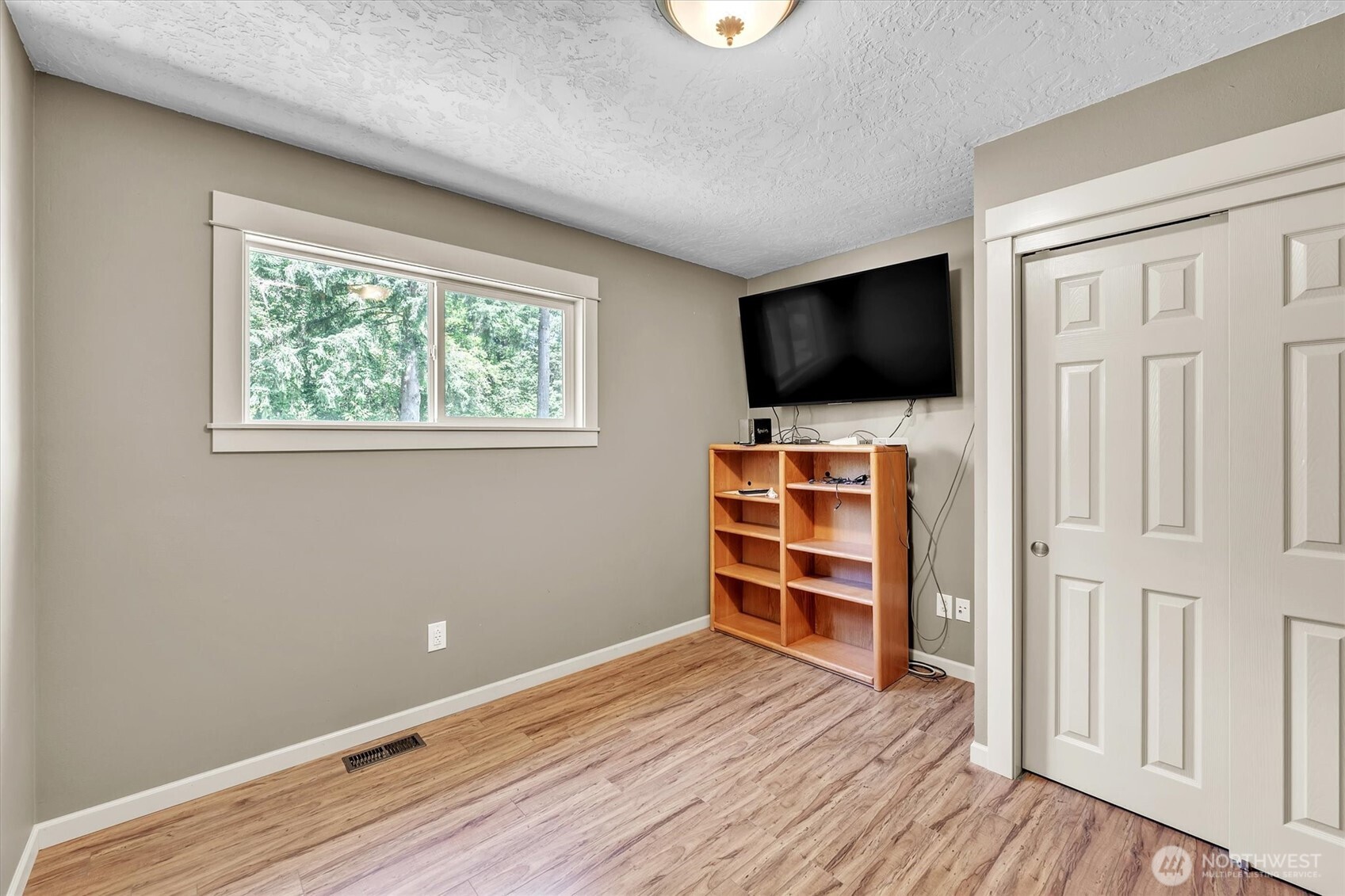231 Robertson Road Longview, WA 98632 - Photo 23 of 37 an empty room with wooden floor closet and windows