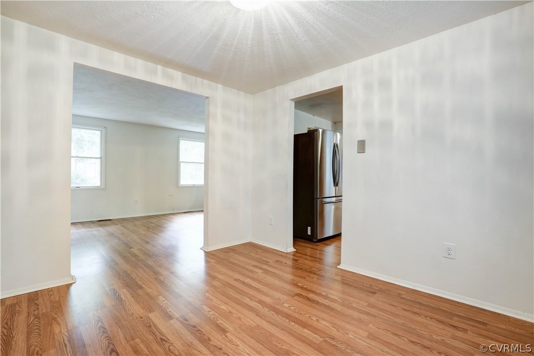 13818 Sutters Mill Road Midlothian, VA 23112 - Photo 10 of 37 a view of an empty room with wooden floor and a window