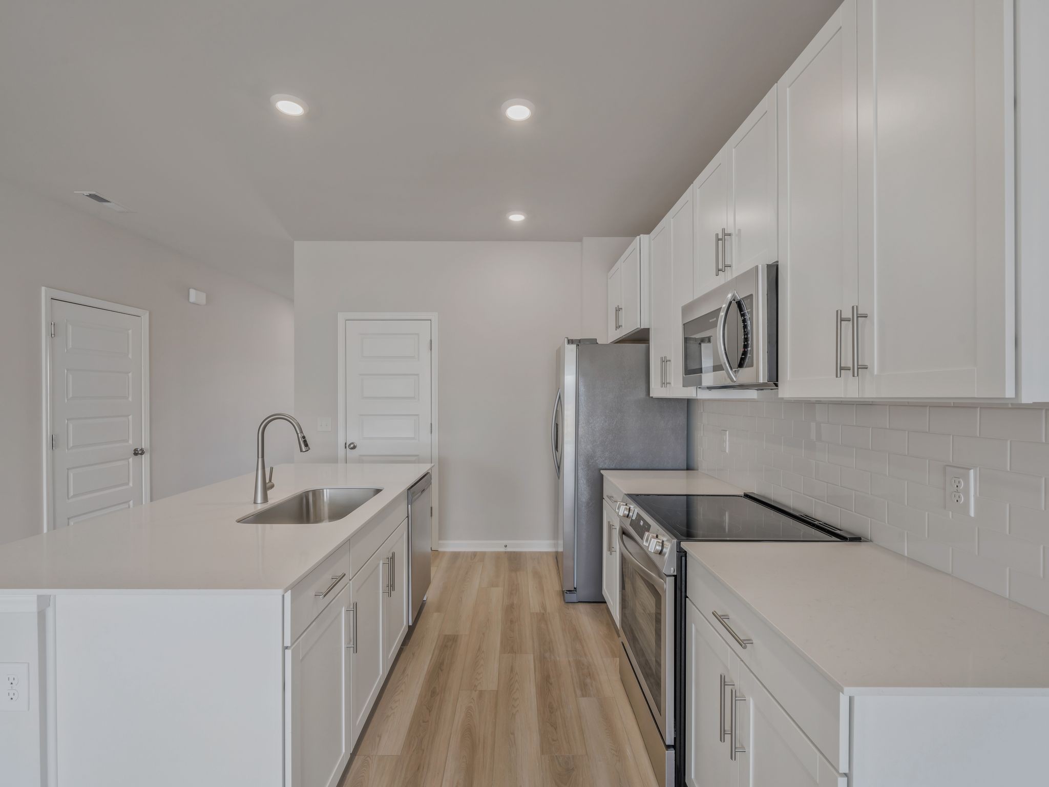 620 Shoemaker Lane Clarksville, TN 37043 - Photo 5 of 13 a kitchen with stainless steel appliances granite countertop a sink and dishwasher a refrigerator with white cabinets