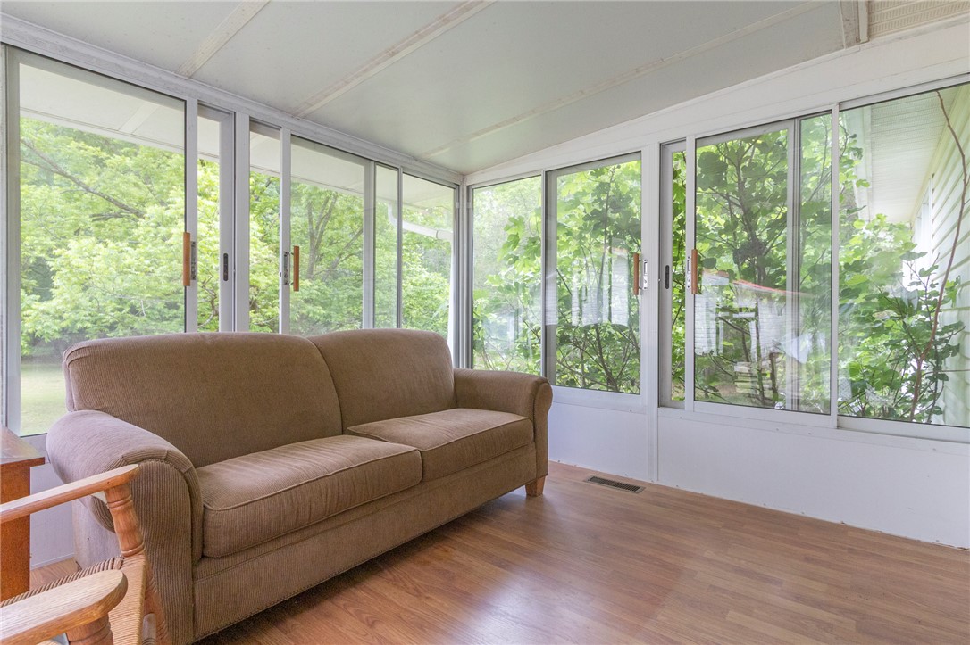 1116 Leatherdale Road Iva, SC 29655 - Photo 33 of 46 This bright sunroom offers tranquil views of nature, ideal for peaceful relaxation.