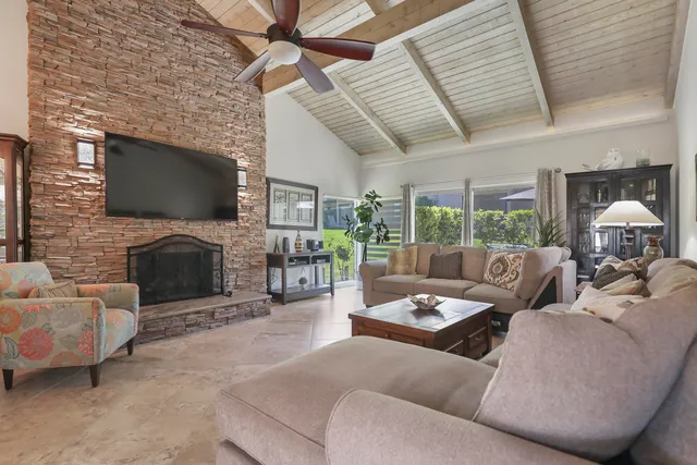 a living room with fireplace furniture and a flat screen tv