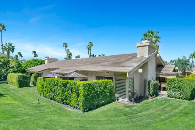 a view of a building with mountains in the background
