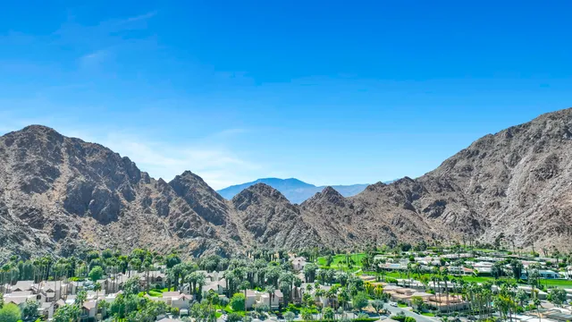 a view of a large mountain with mountains in the background