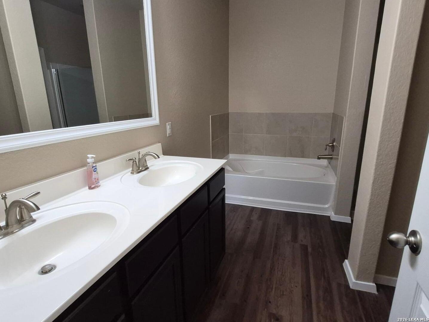 7102 Zuma Beach Converse, TX 78109 - Photo 17 of 31 a bathroom with a sink a tub and a mirror