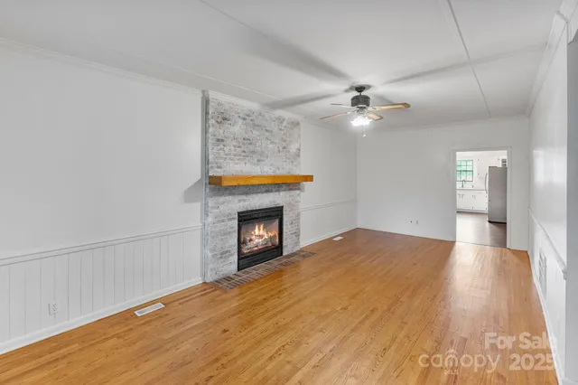 wooden floor in an empty room with a fireplace