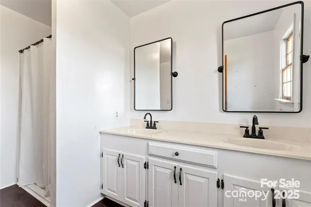 a bathroom with a double vanity sink and mirror