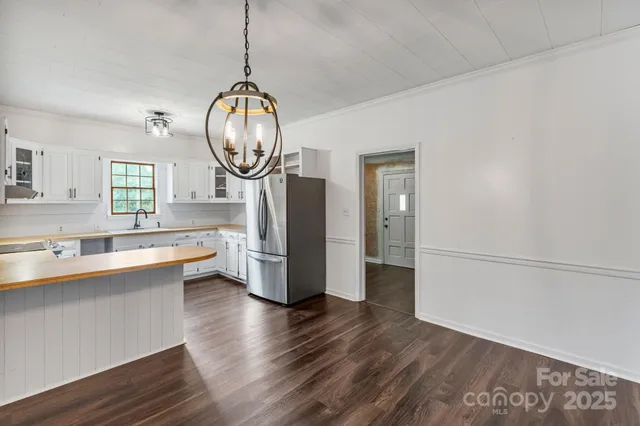 a view of a kitchen with wooden floor and a sink
