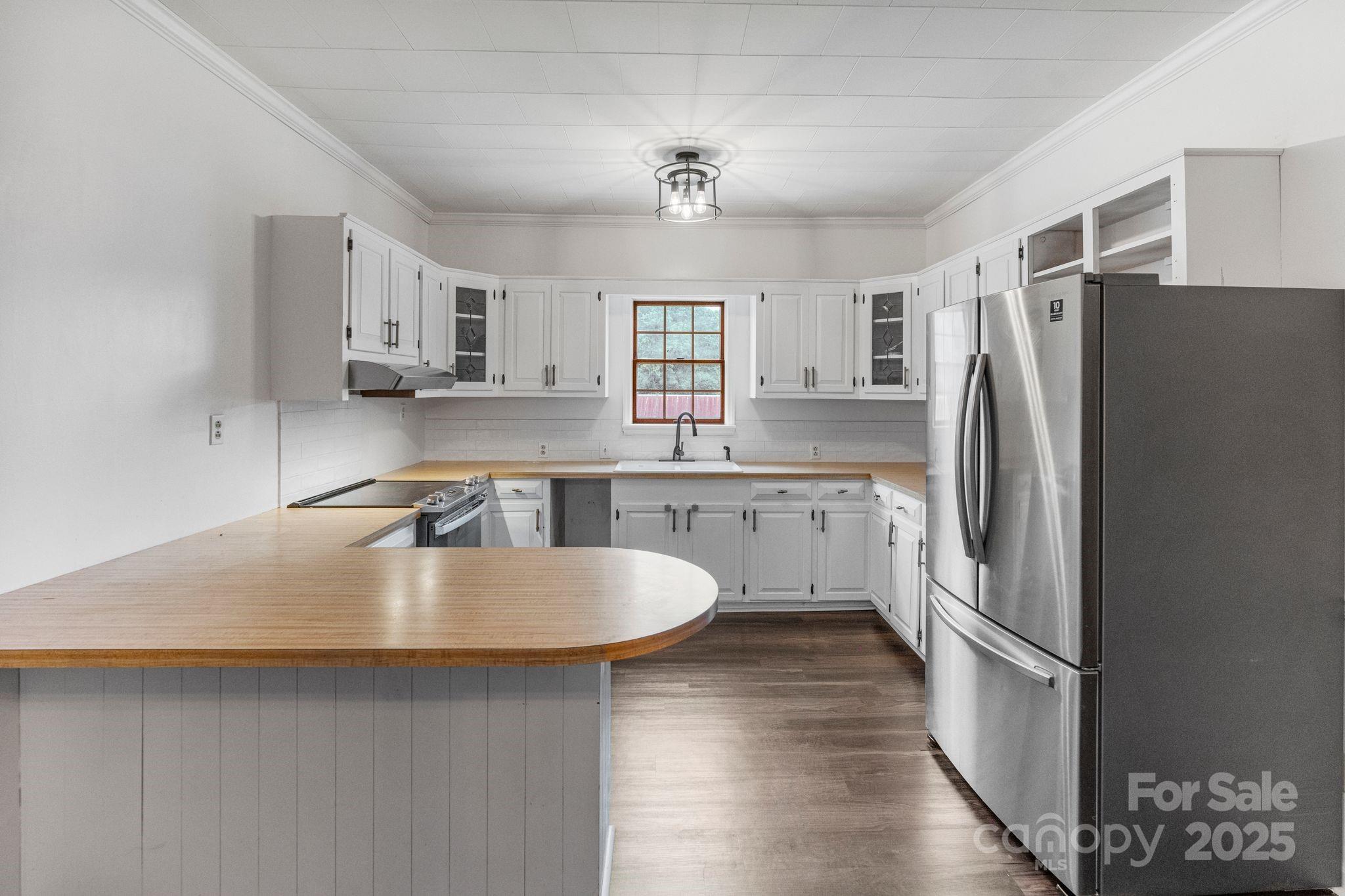 956 Stoney Point Road Kings Mountain, NC 28086 - Photo 22 of 48 a kitchen with stainless steel appliances granite countertop a sink stove and refrigerator