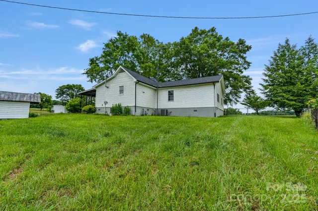 a house with green field in front of it