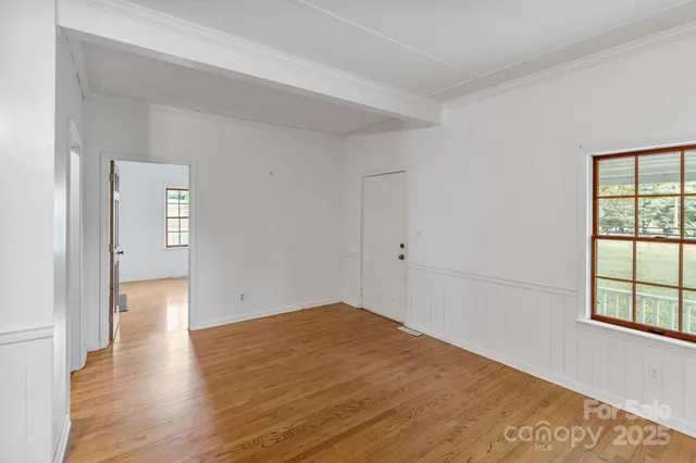 wooden floor in an empty room with a window