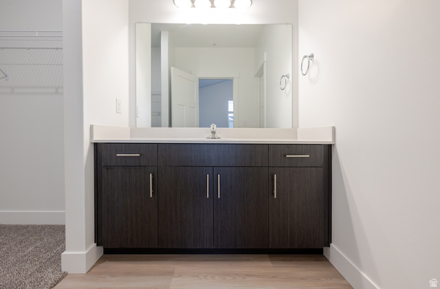 4661 Poplar Way, Unit R303 Mapleton, UT 84664 - Photo 9 of 17 Bathroom featuring vanity, a spacious closet, and light wood finished floors