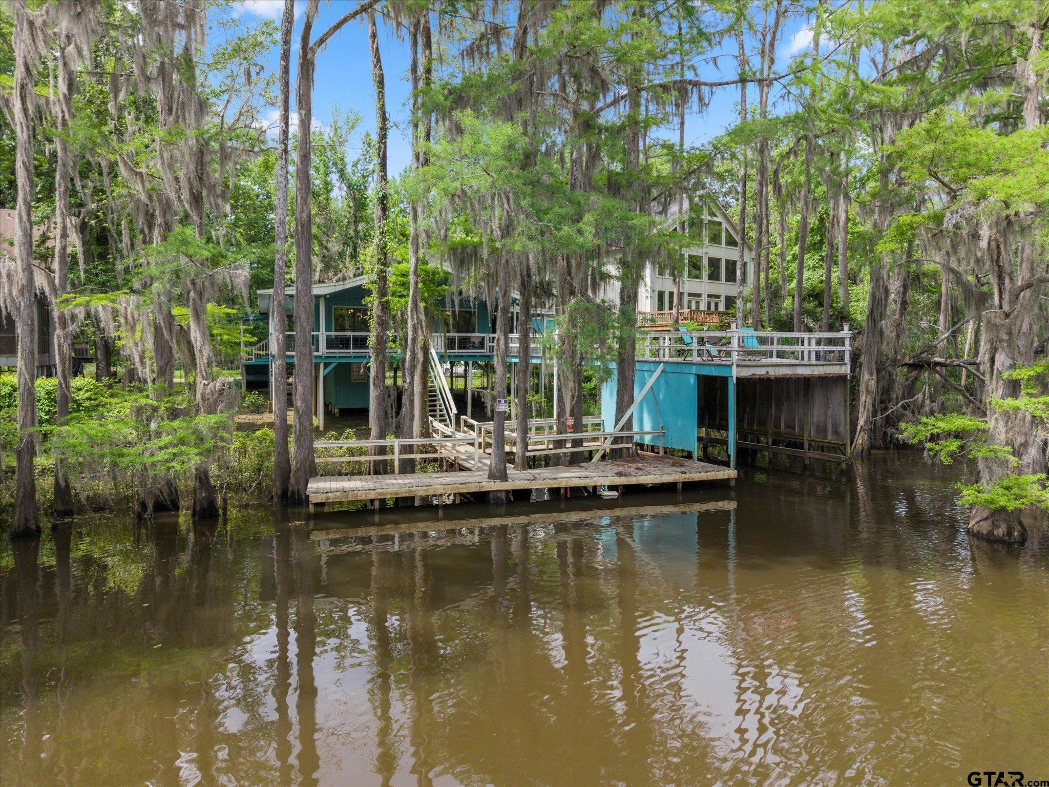 230 Sesame Street West Karnack, TX 75661 - Photo 25 of 44 a view of house with swimming pool and lake view