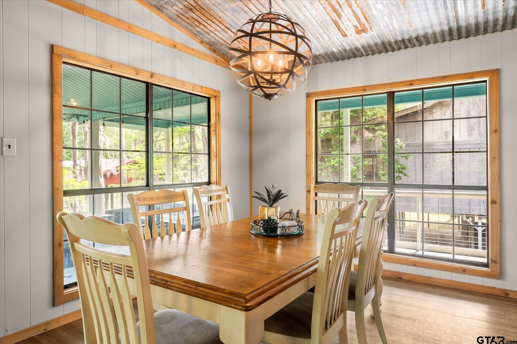230 Sesame Street West Karnack, TX 75661 - Photo 37 of 44 a dining room with furniture a chandelier and wooden floor