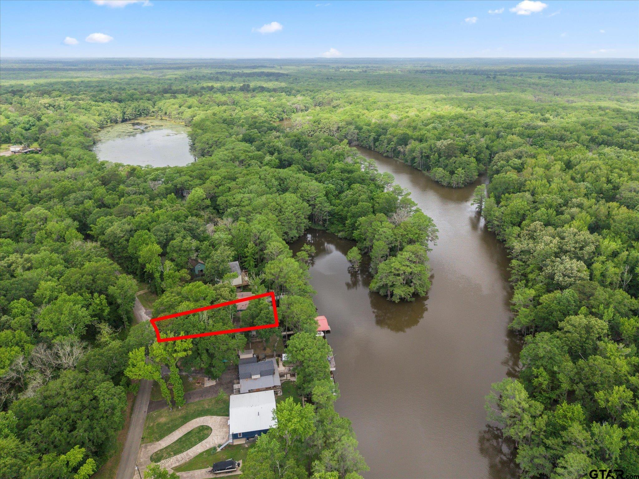 230 Sesame Street West Karnack, TX 75661 - Photo 44 of 44 a view of a lake with a yard