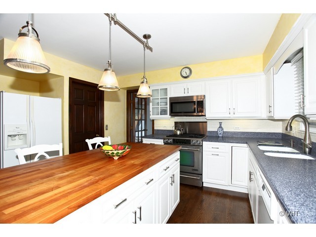 1933 Pine Road Lisle, IL 60532 - Photo 2 of 12 a kitchen with stainless steel appliances granite countertop a sink a stove and a microwave