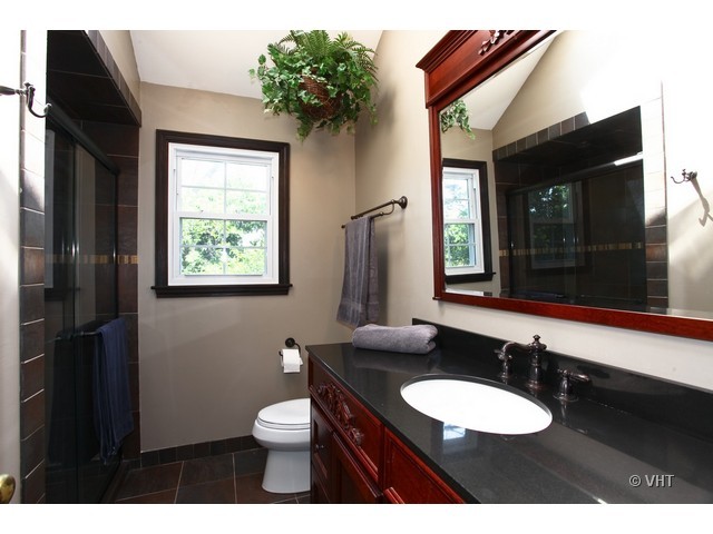 1933 Pine Road Lisle, IL 60532 - Photo 8 of 12 a bathroom with a toilet a sink and mirror