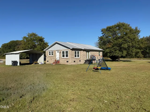 a view of house with backyard and deck