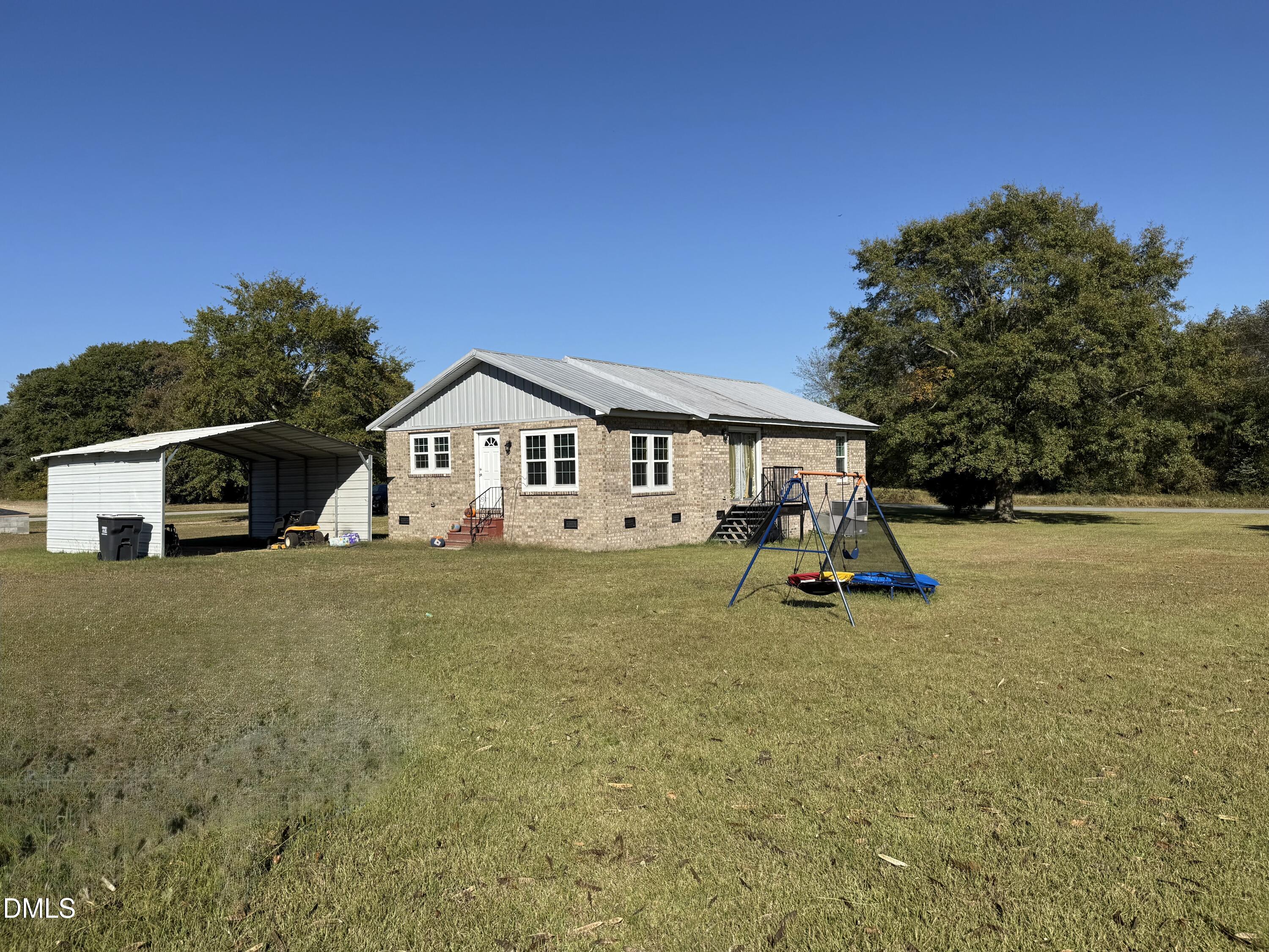 130 Fitzgerald Road Selma, NC 27576 - Photo 3 of 18 a view of house with backyard and deck
