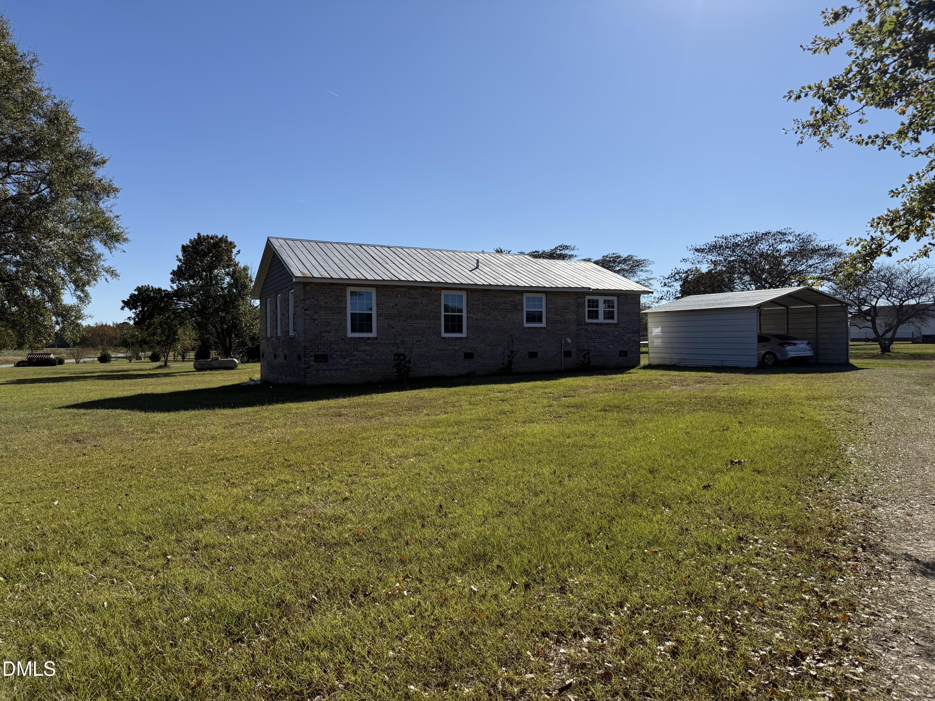 130 Fitzgerald Road Selma, NC 27576 - Photo 7 of 18 a view of a large pool with lawn chairs under an umbrella