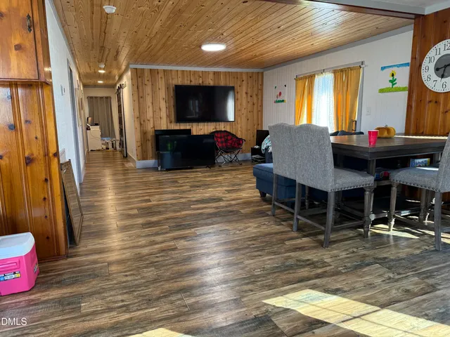 a living room with furniture a flat screen tv and a table