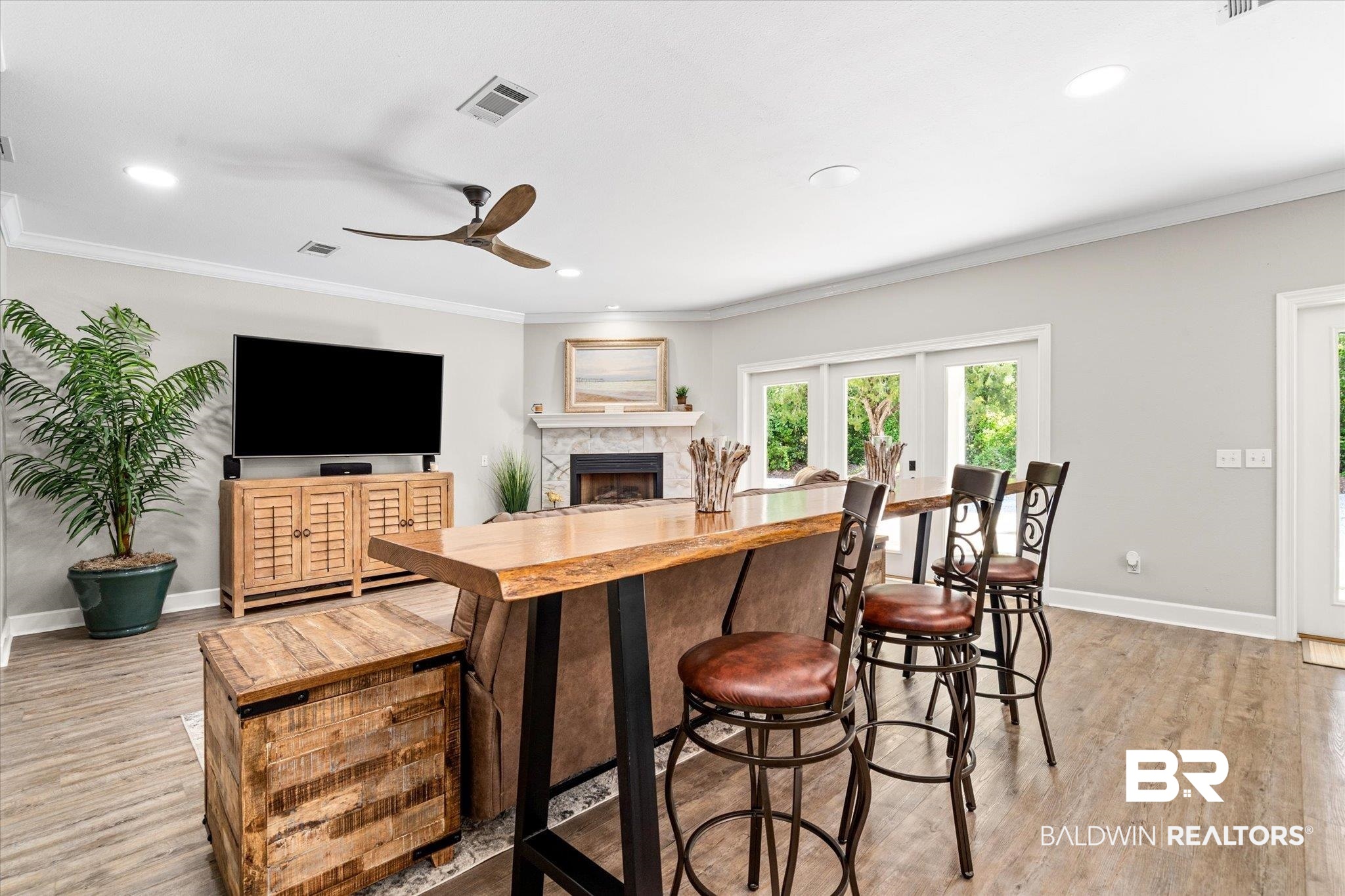 4947 Look Rook Road Orange Beach, AL 36561 - Photo 4 of 24 Kitchen featuring crown molding, light wood-style flooring, a ceiling fan, visible vents, and baseboards