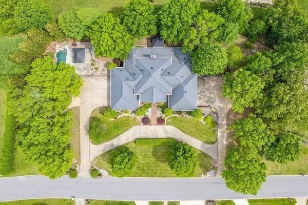 an aerial view of residential houses with outdoor space and street view