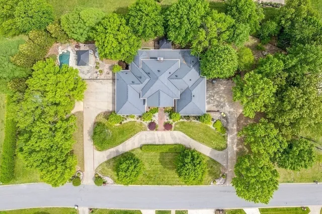 an aerial view of residential houses with outdoor space and street view