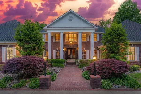 a front view of a house with a garden