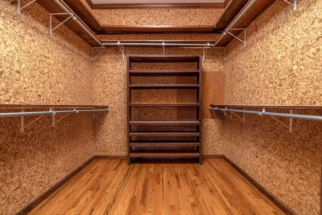 a kitchen with stainless steel appliances granite countertop a refrigerator a sink and white cabinets